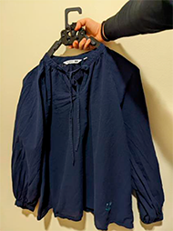 : The 3 images show how the new assistive hanger expands and holds 3 types of cloth, M-size grey T-shirt, long-sleeve navy blue blouse, and M-size ¾ Relaco pants.